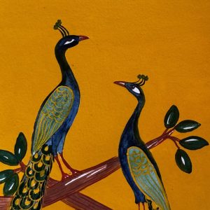 Two peacocks on a branch