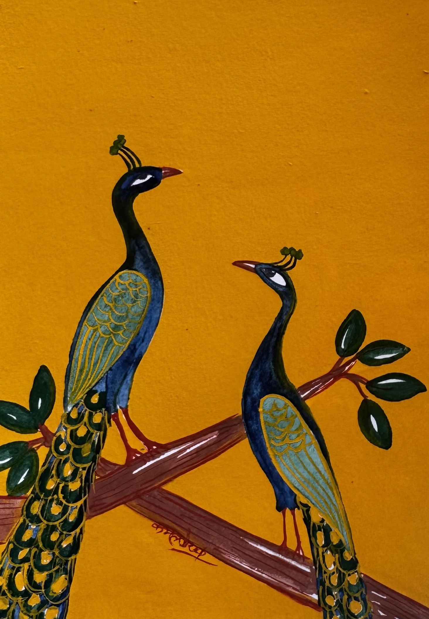 Two peacocks on a branch